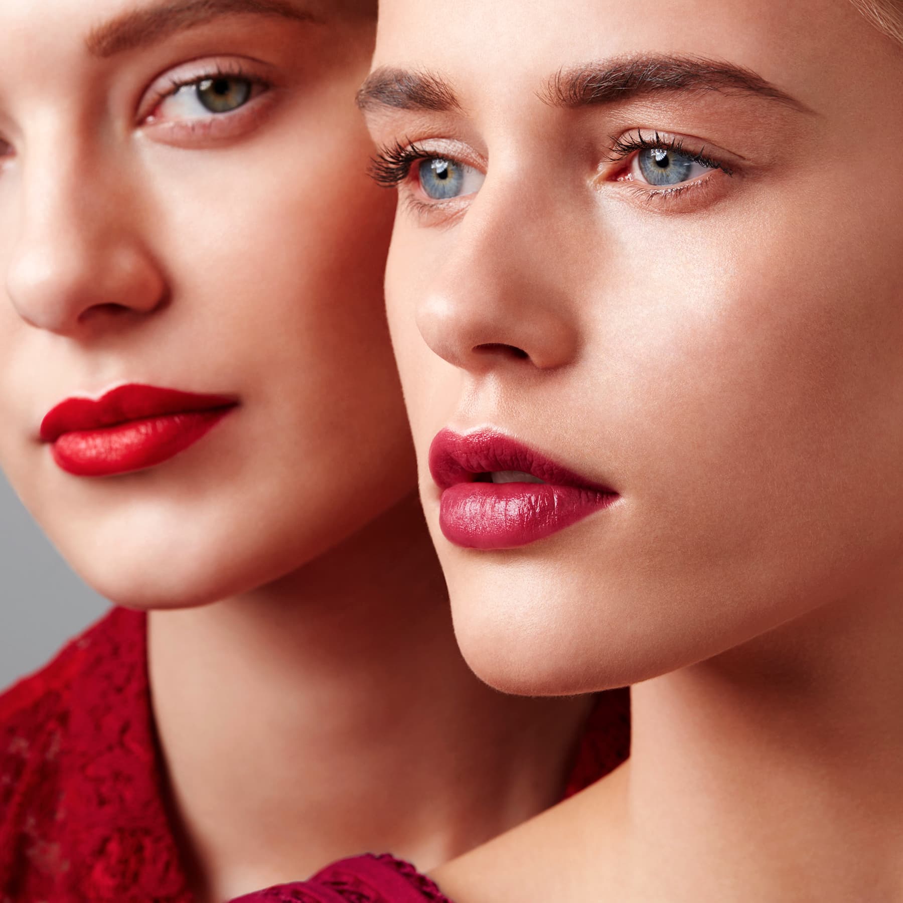 CLOSE UP OF TWO YOUNG WOMAN RED LIPSTICK
